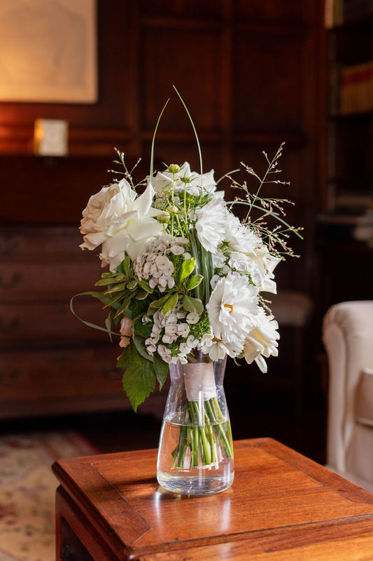 White garden rose and cosmos bridal bouquet in clear vase by Kvetka Flower Portland, library setting at The Town Club