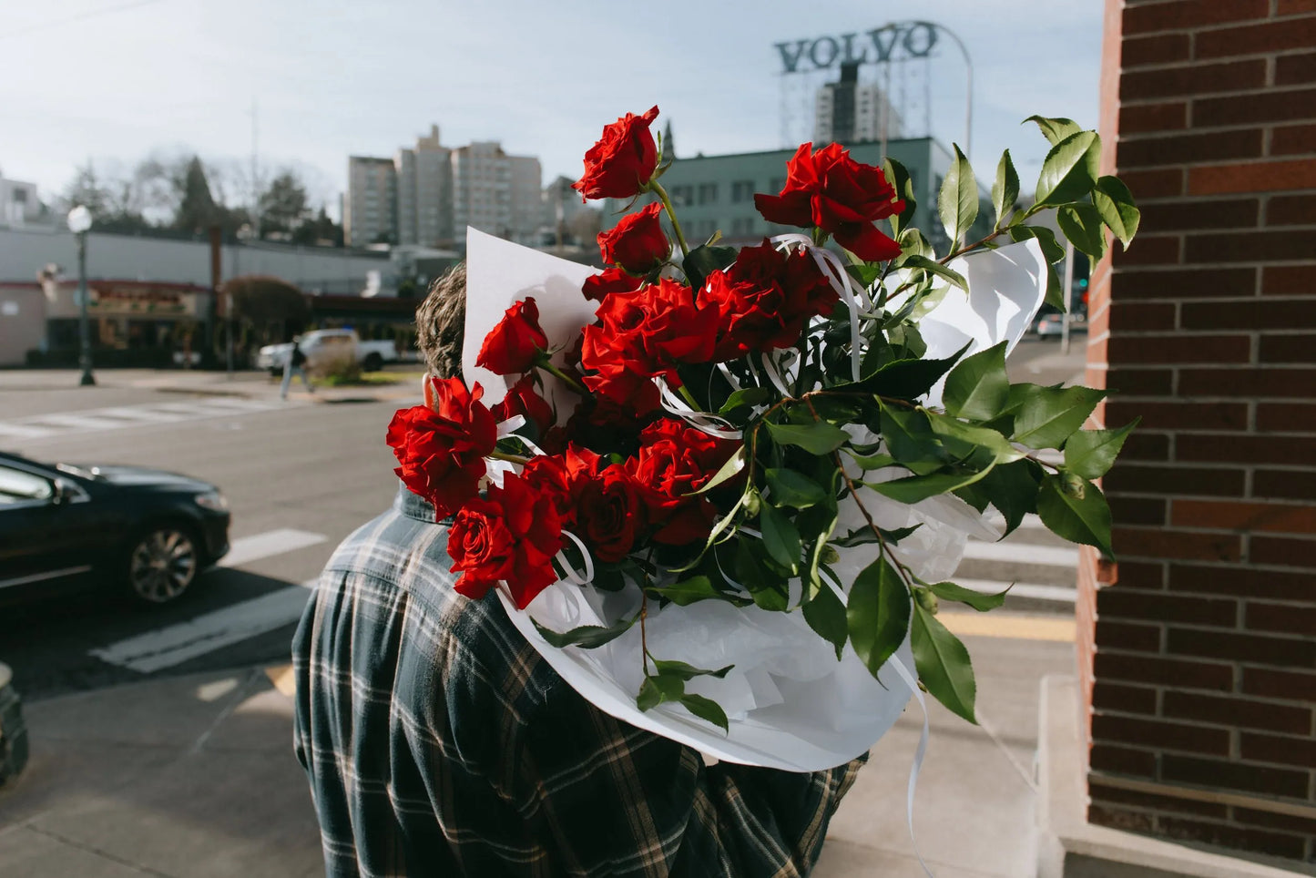 Large Valentine red roses bouquet carried over shoulder in Portland