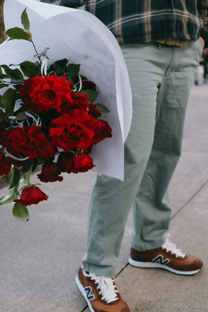 Valentine red roses bouquet with lush greenery ready for gifting