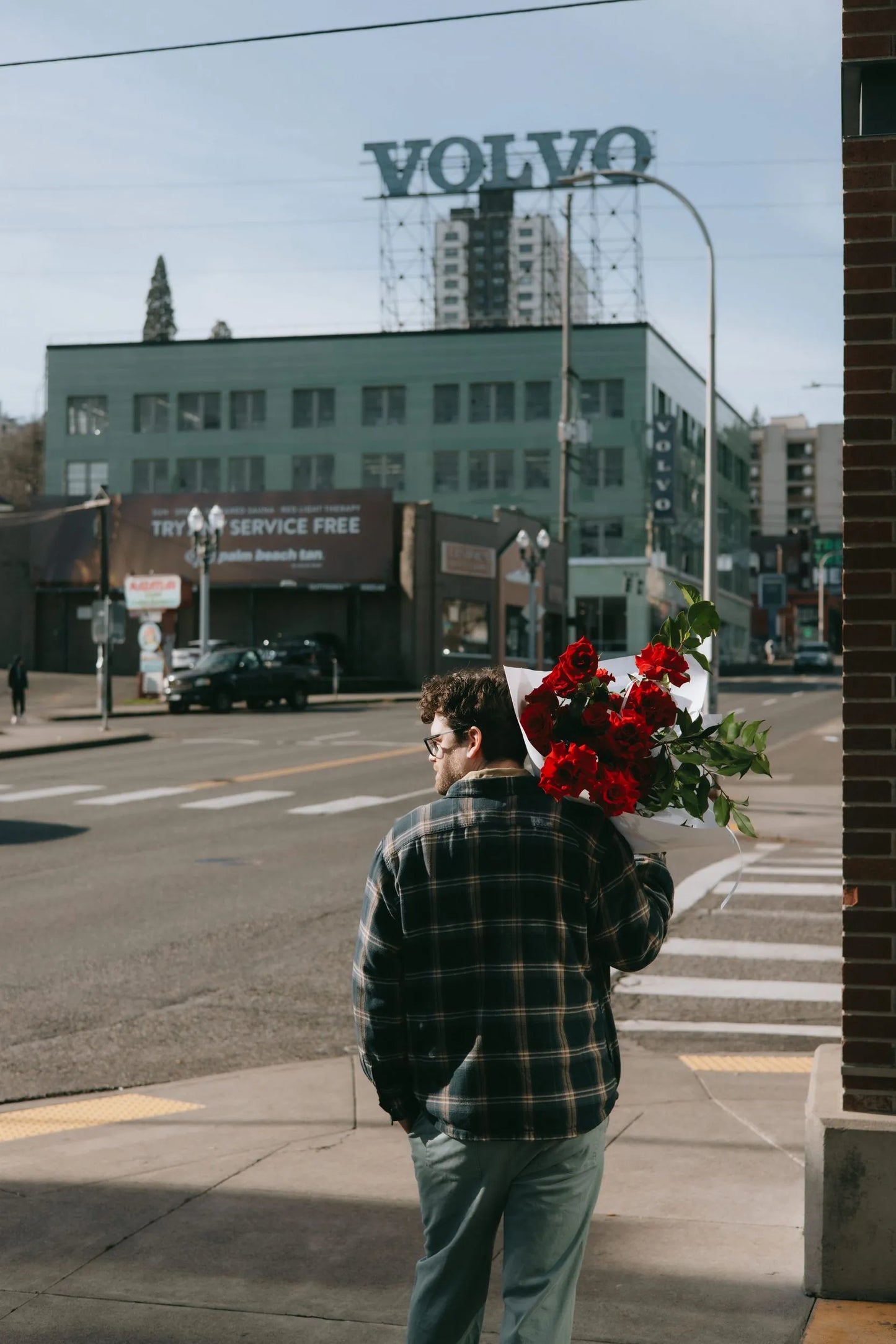 Man walking with 24 red roses bouquet for Valentine's Day delivery in Portland