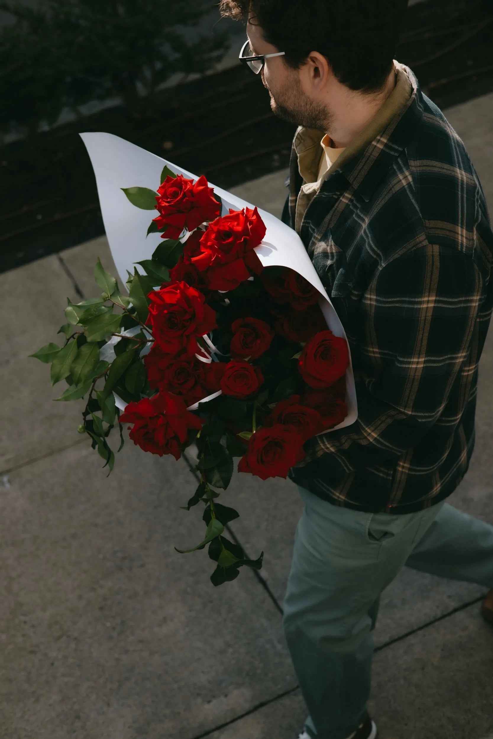 Two dozen red roses Valentine bouquet with greenery from above