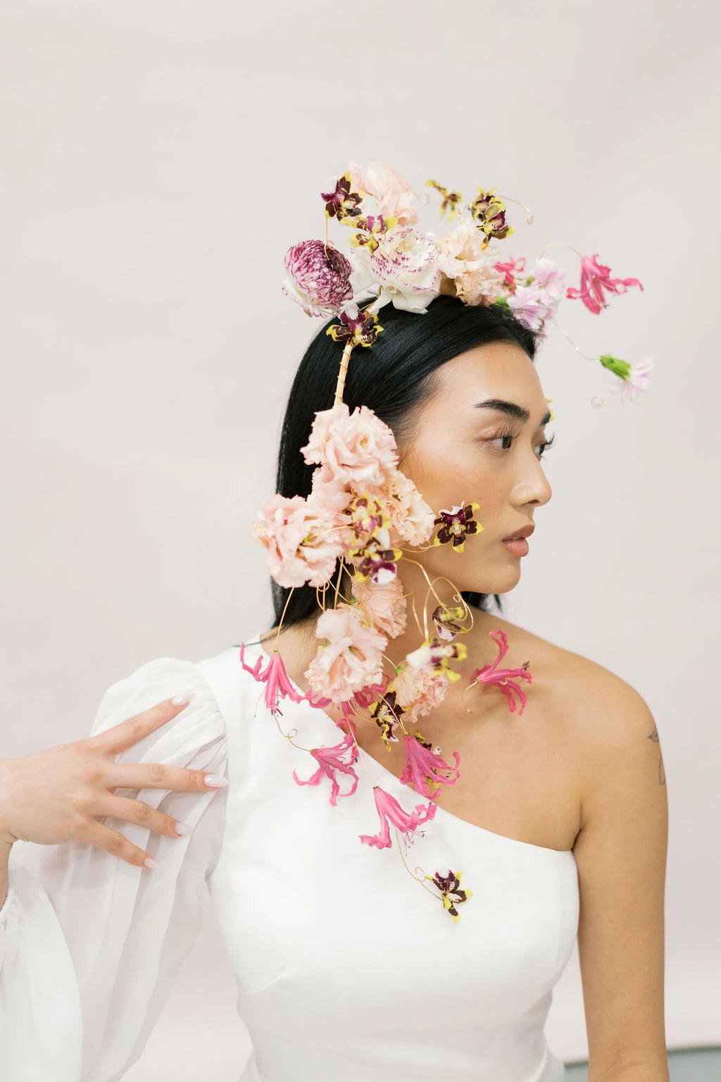 Bride profile wearing artistic wire-frame flower crown with pink nerine and blush lisianthus Kvetka Flower