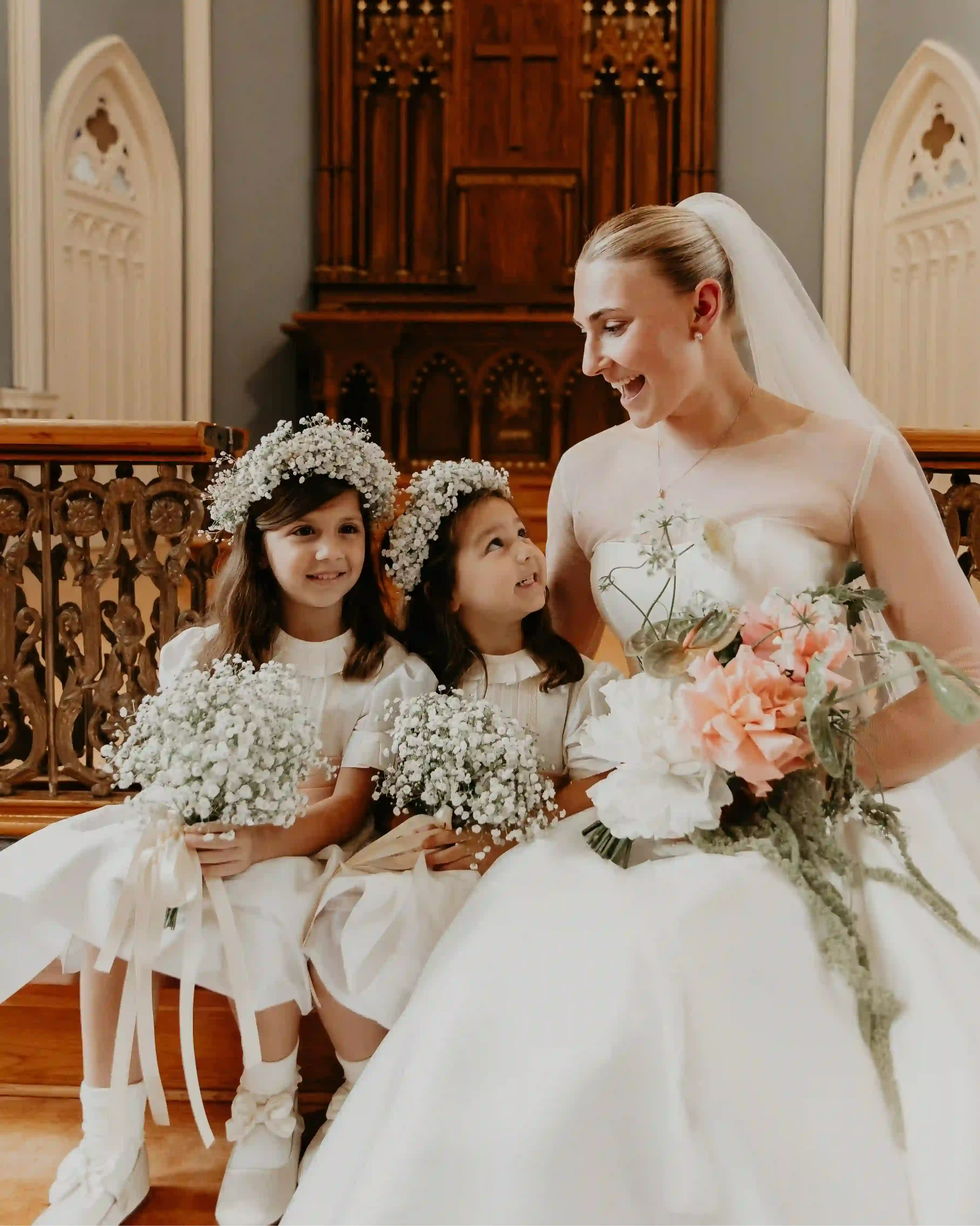 Bride with flower girls holding baby's breath bouquets and a garden-style bridal bouquet — wedding by Kvetka Flower in Vancouver, near Portland OR.