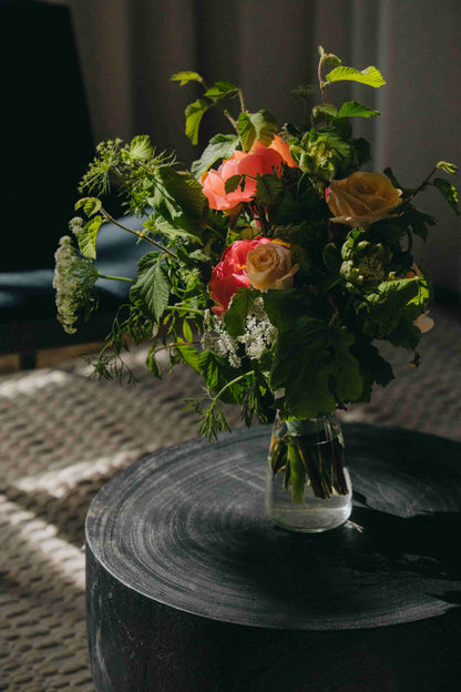 Light peach and coral rose bouquet in glass vase – floral subscription Portland