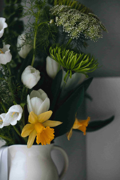 Green mums, white tulips and daffodils in ceramic pitcher – part of Kvetka Flower’s Deluxe Subscription Portland
