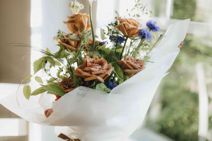 White ornithogalum and amber roses in a soft natural light — Portland flower delivery