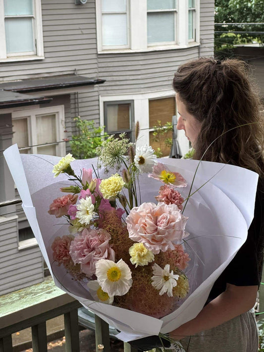 Medium fresh seasonal bouquet with blush garden roses, icelandic poppies, carnations and cosmos wrapped in white paper, by Kvetka Flower Portland