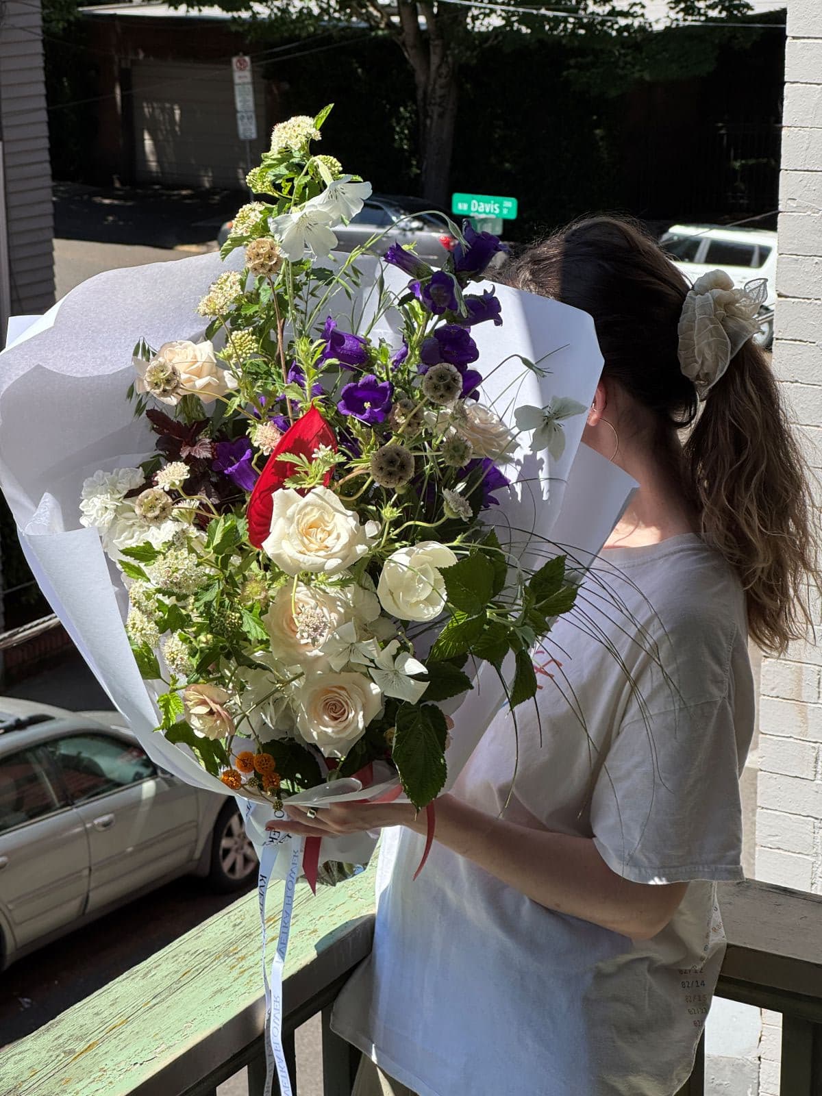 Fresh seasonal summer bouquet with cream roses, purple campanula, stock, scabiosa, and raspberry greenery by Kvetka Flower Portland