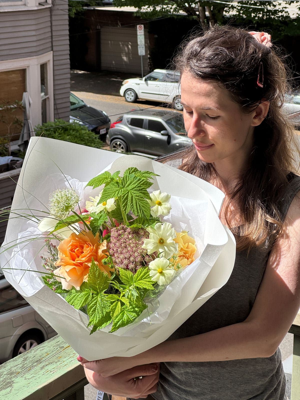 Fresh seasonal summer bouquet with peach garden rose, ranunculus, allium, white calla lilies, and greenery by Kvetka Flower Portland