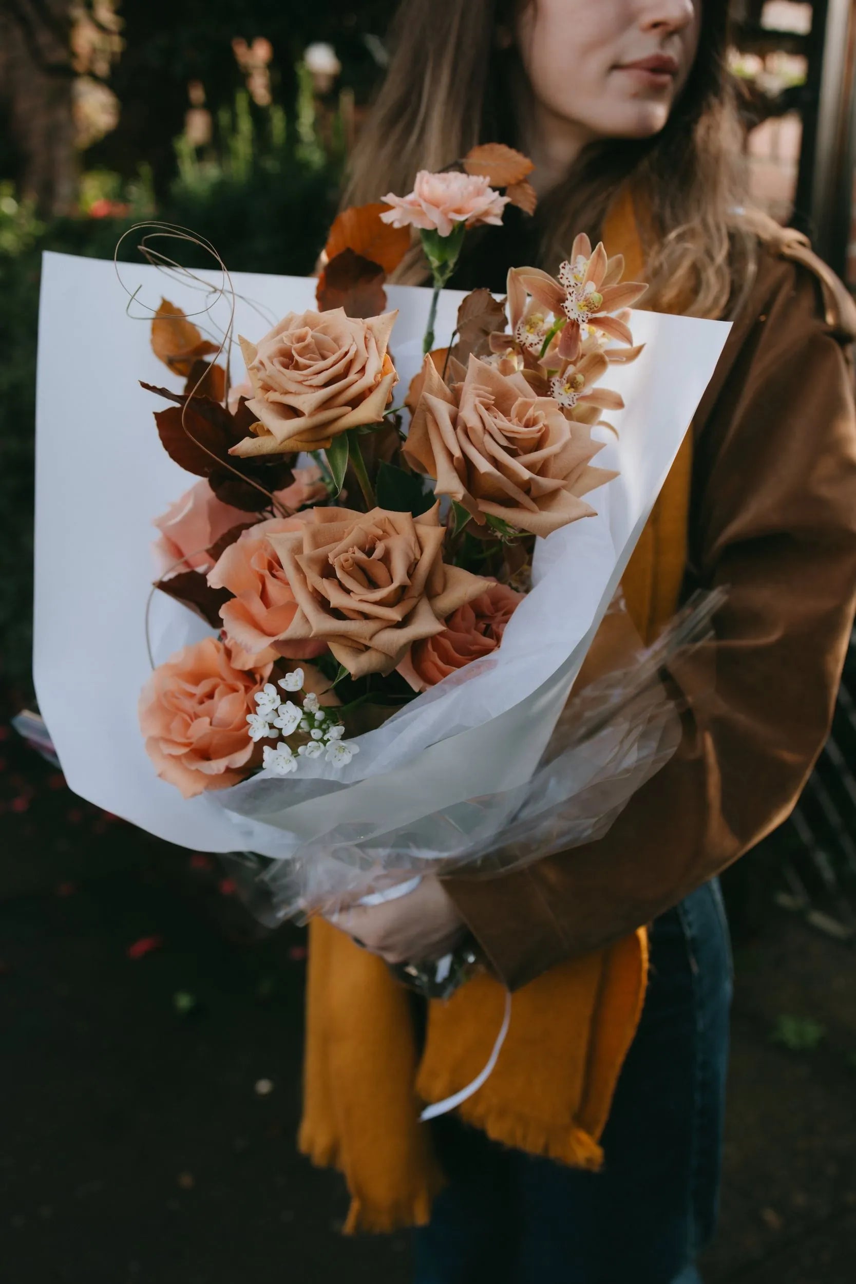 Toffee roses with cymbidium orchids and peach carnations luxury bouquet