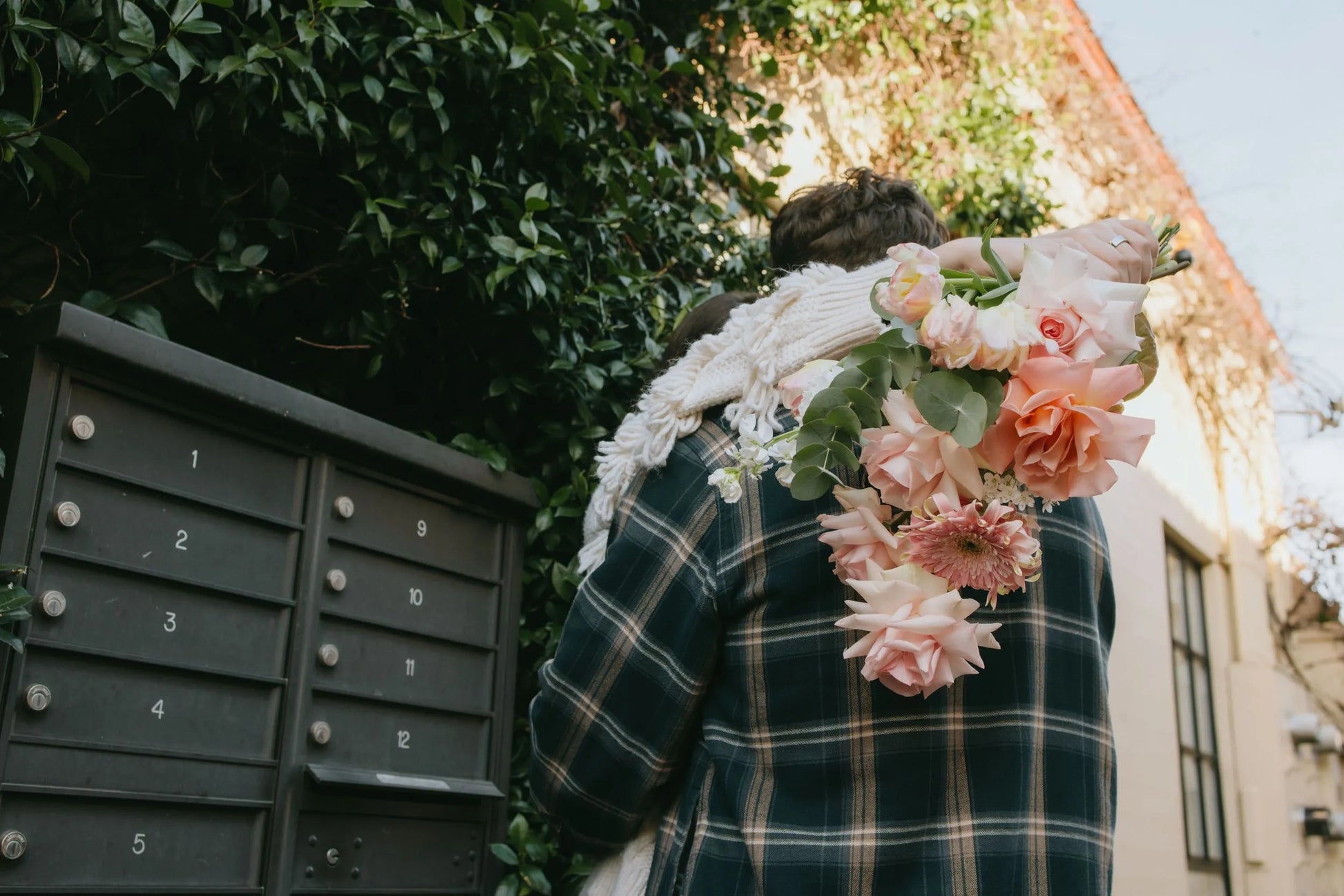 Couple hugging with soft pink roses bouquet in Portland