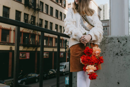 Woman holding bright roses bouquet in downtown Portland
