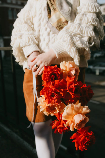 Close-up of vibrant red and peach roses premium bouquet