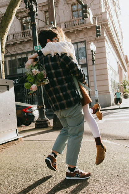 Couple with wild bouquet on downtown Portland street