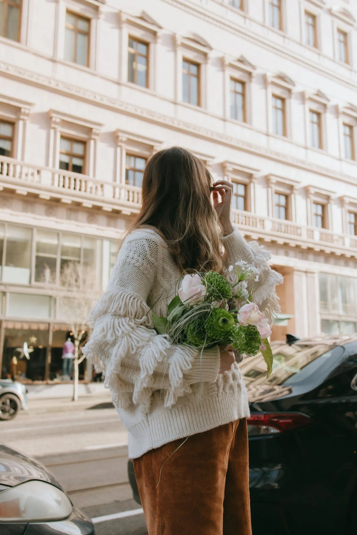 Woman carrying premium green bouquet in downtown Portland
