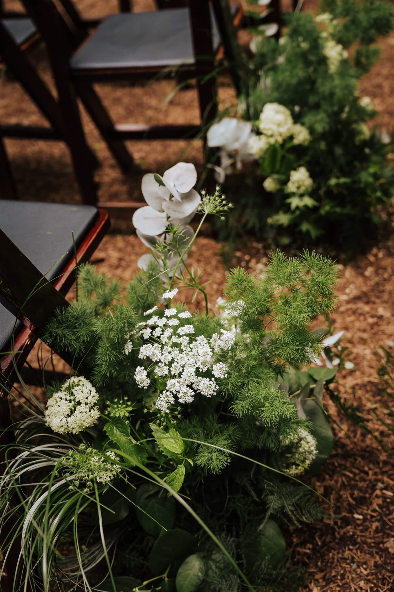 Close-up of aisle flowers with Queen Anne’s lace and eucalyptus at Camp Colton – by Kvetka Flower, Portland OR
