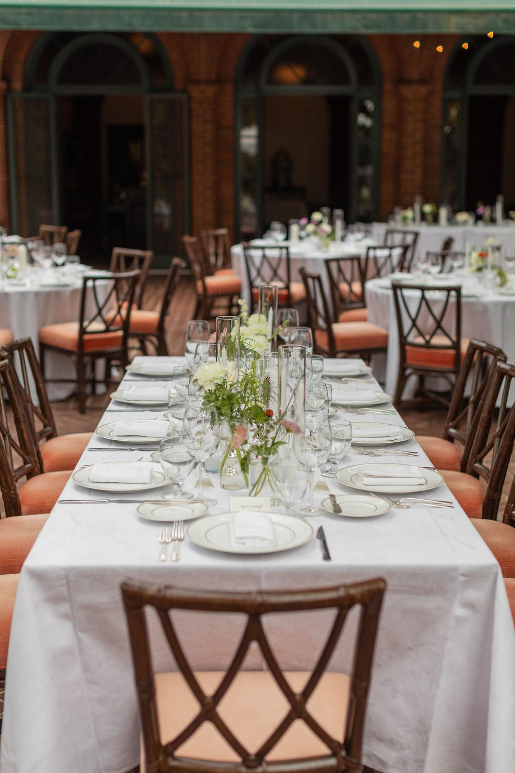 Long bridal party table with clear glass bud vase runner and seasonal flowers at The Town Club Portland by Kvetka Flower