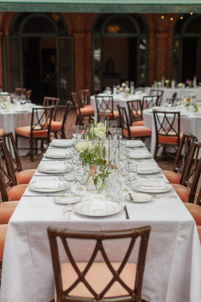 Long bridal party table with clear glass bud vase runner and seasonal flowers at The Town Club Portland by Kvetka Flower