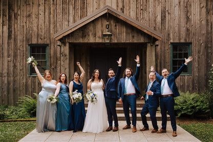 Bride and groom standing formally in front of wooden chapel at Camp Colton – by Kvetka Flower, Portland OR
