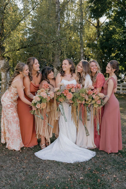 Candid bridal party photo with fall wedding bouquets featuring chrysanthemums and trailing greenery, Portland Oregon