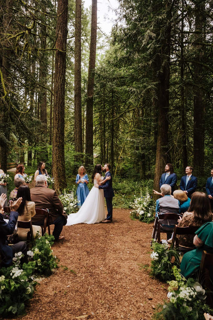 Bride and groom kiss at the altar during forest wedding ceremony at Camp Colton – by Kvetka Flower, Portland OR