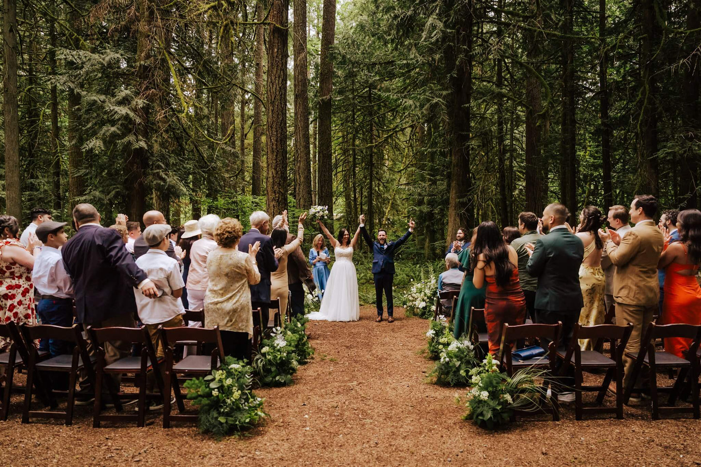 Bride and groom kissing during ceremony exit at Camp Colton forest wedding – by Kvetka Flower, Portland OR
