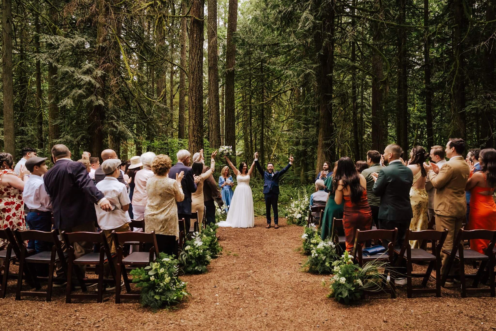 Bride and groom kissing during ceremony exit at Camp Colton forest wedding – by Kvetka Flower, Portland OR

