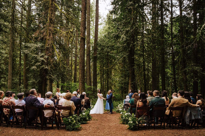Wide shot of the ceremony in the woods at Camp Colton with guests and floral decor – by Kvetka Flower, Portland OR
