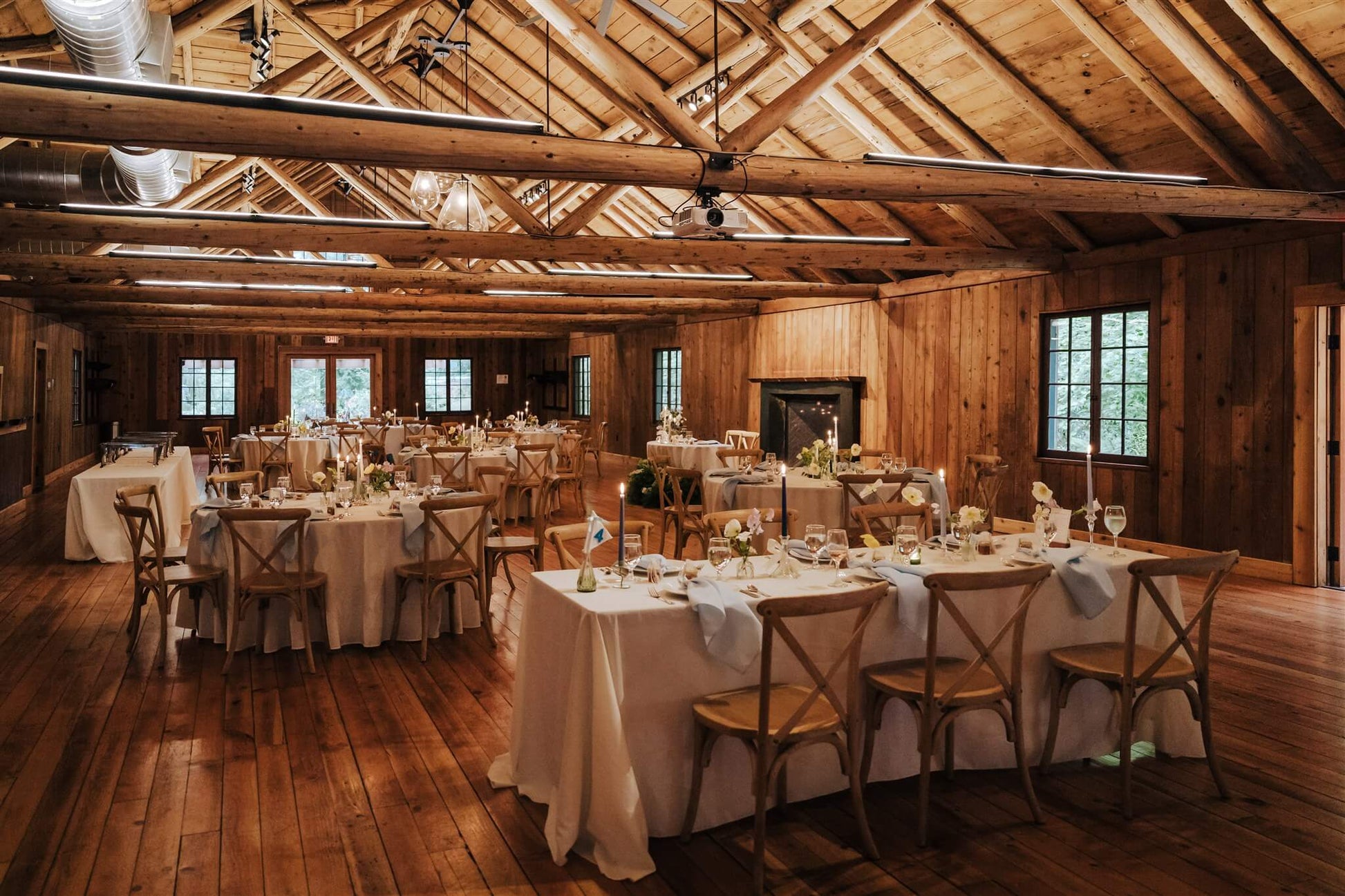 Camp Colton wedding reception hall with decorated tables and candles – by Kvetka Flower, Portland OR
