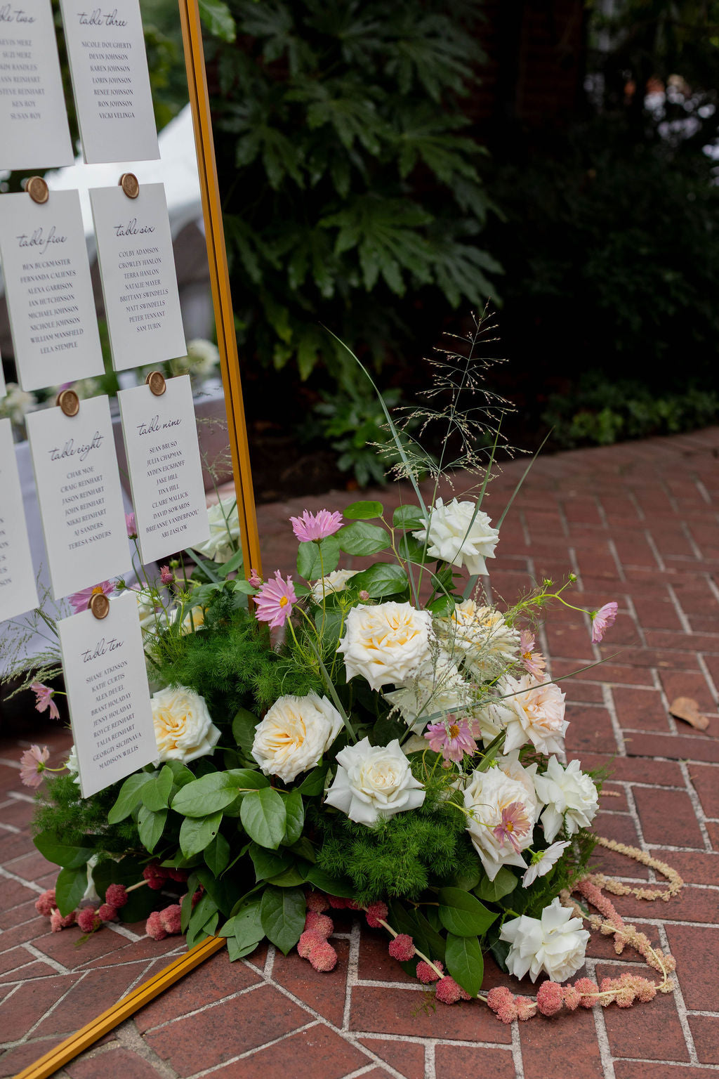 Floor floral arrangement with white garden roses, pink cosmos and trailing amaranthus at wedding seating chart by Kvetka Flower Portland