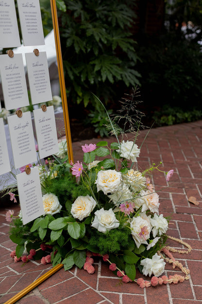 Floor floral arrangement with white garden roses, pink cosmos and trailing amaranthus at wedding seating chart by Kvetka Flower Portland