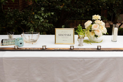 Wedding shotski guestbook table with white rose and trailing amaranthus arrangement by Portland florist Kvetka Flower