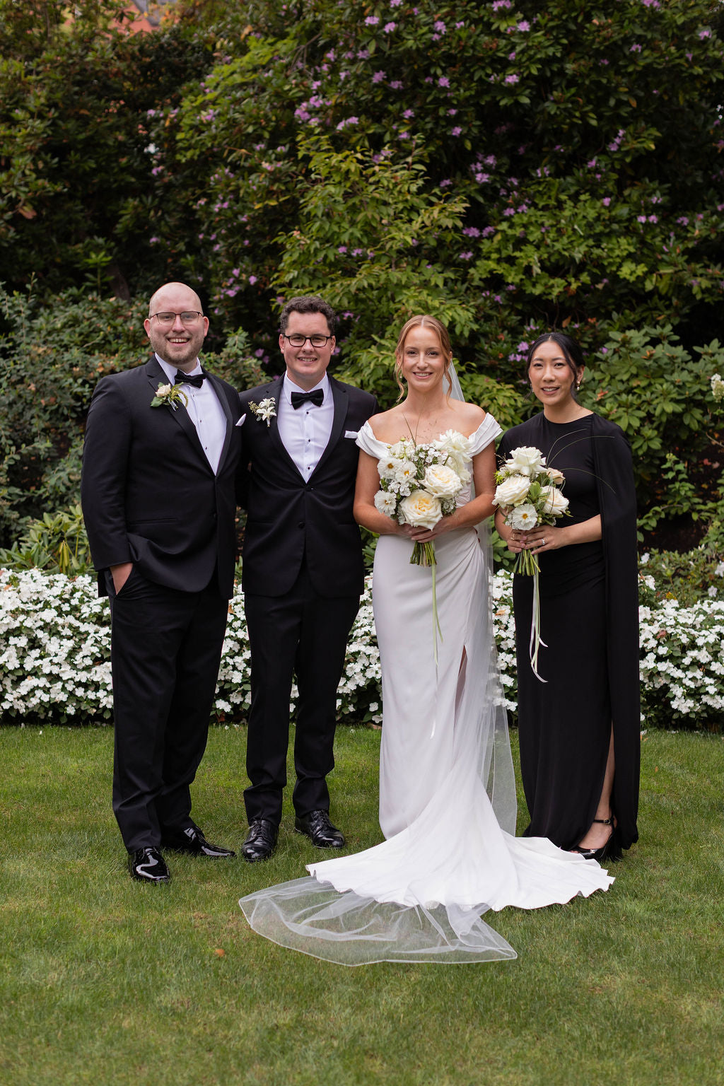 Wedding party at The Town Club Portland with white garden rose bridal bouquet and trailing bridesmaid bouquet by Kvetka Flower